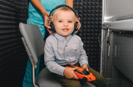 Child with headphones getting hearing tested