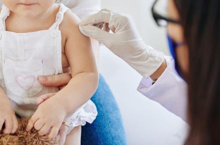 toddler having their arm prepped for immunization