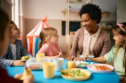 kids gathered around a table with an adult