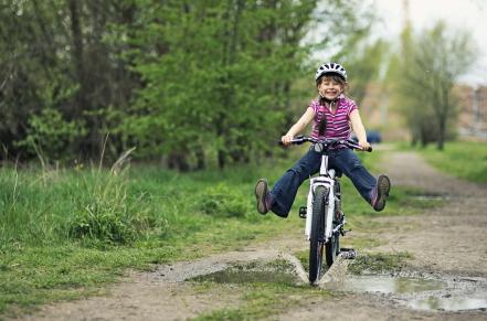 Child riding a bike outdoors