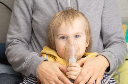 Child with nebulizer around mouth and nose