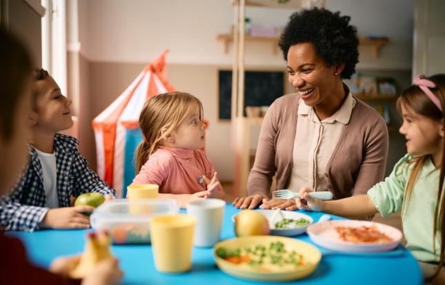 kids gathered around a table with an adult