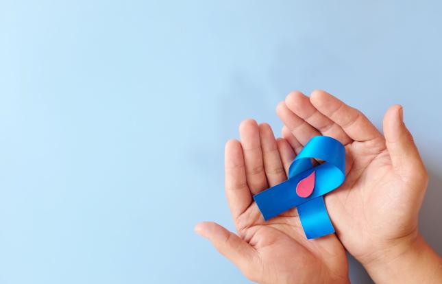 hands holding a diabetes awareness ribbon (blue)