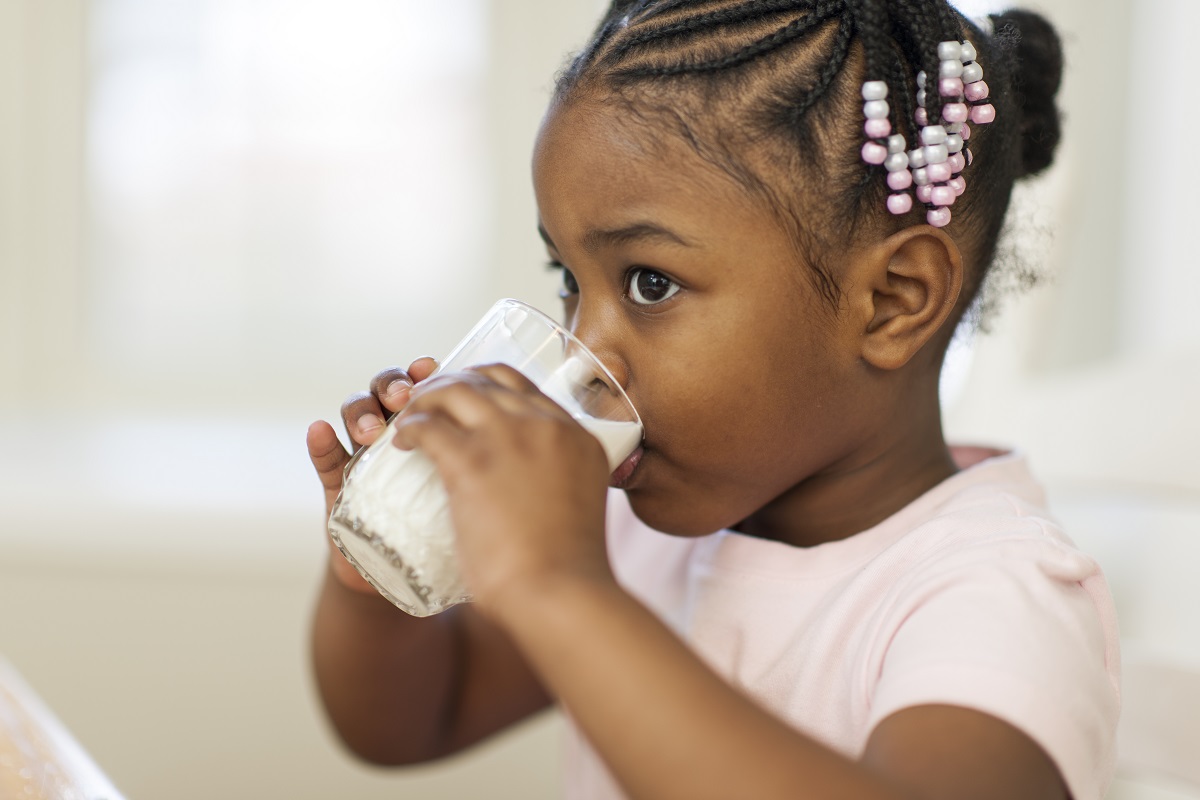 Child drinking a glass of milk